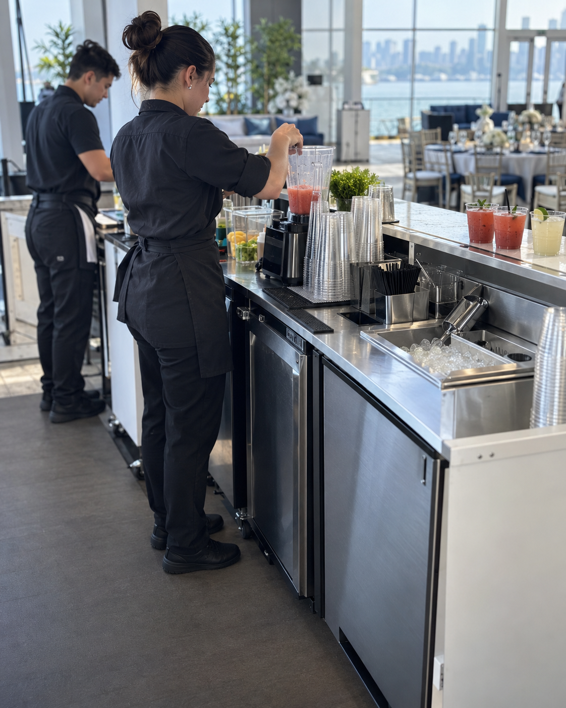 Barista working at a stainless steel bar with under-counter equipment