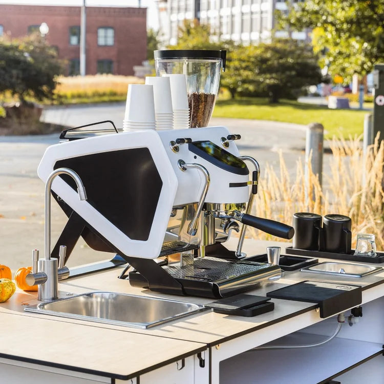 Espresso machine and grinder on a mobile cart set up outdoors