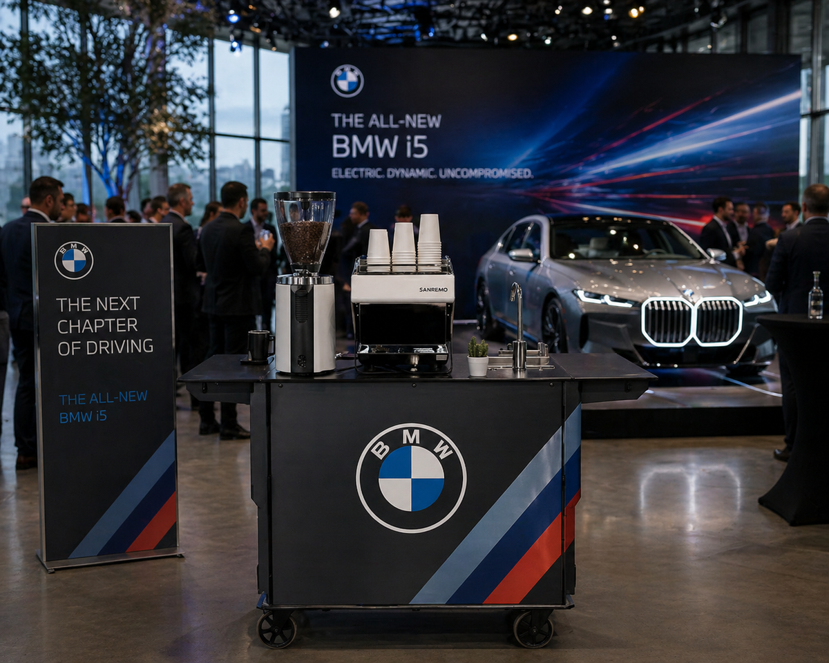Branded espresso bar beside a car on display at an auto show