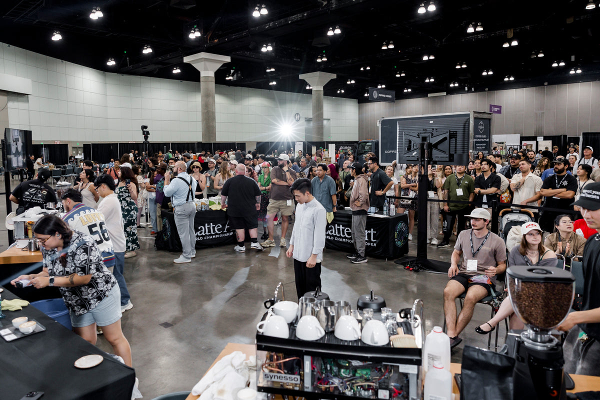 Latte art competition floor with a seated crowd at Coffee Fest Los Angeles, 2025