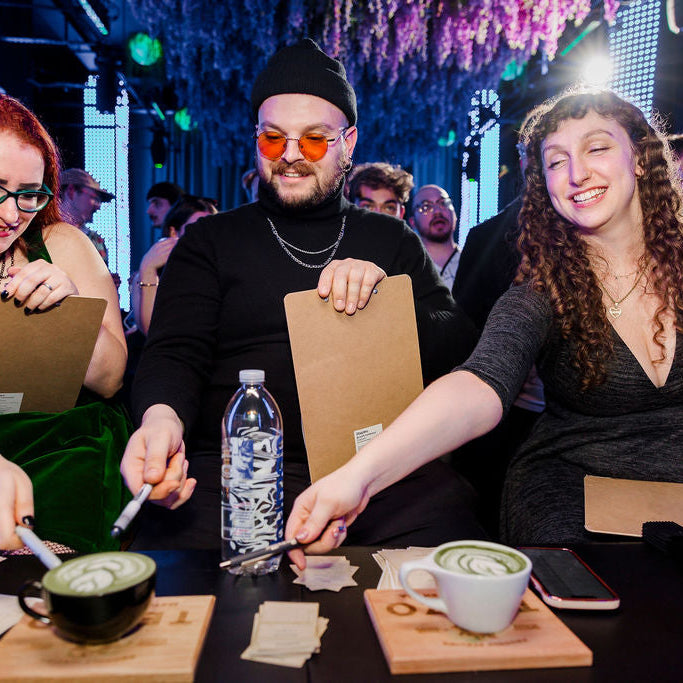 Judges point to the winning cup between two latte art pours at an ESOM throwdown