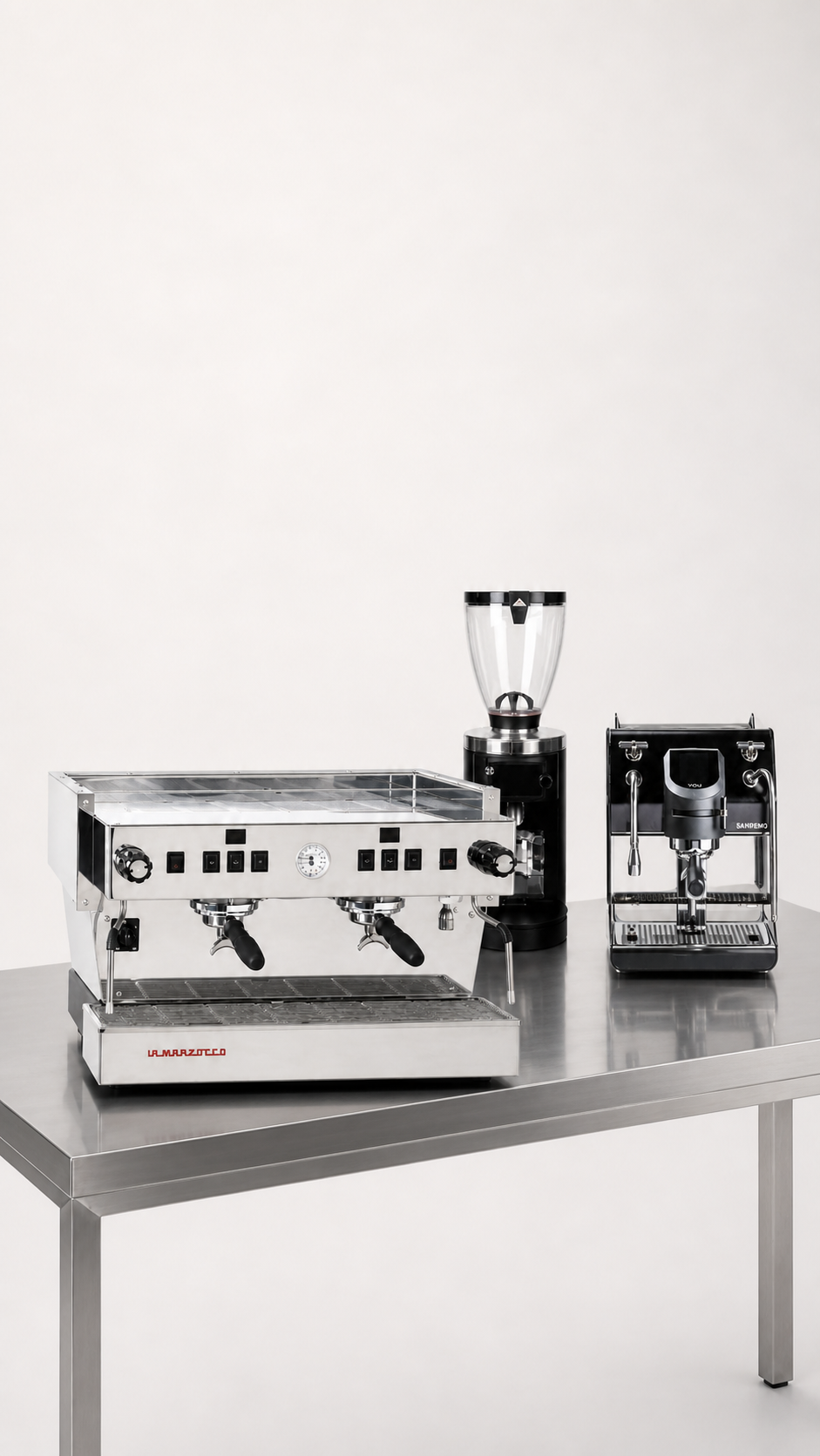 Two-group commercial espresso machine with two grinders on a stainless steel counter